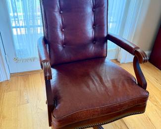 executive leather desk chair featuring classic button tufting and nailhead trim