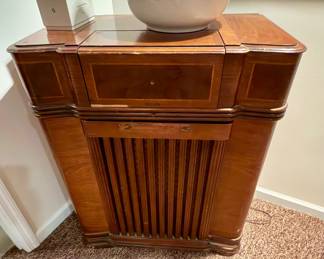 a vintage wooden floor console radio and phonograph cabinet