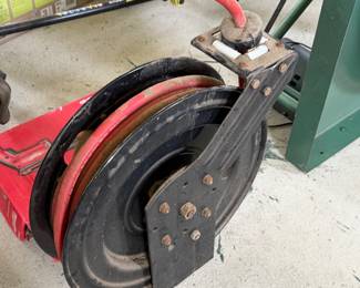 heavy-duty, open-face retractable air hose reel with a red rubber hose