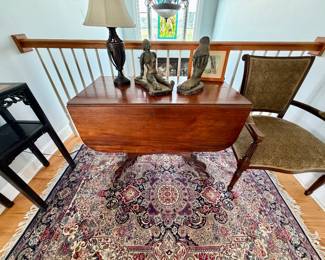 an antique American Empire mahogany drop-leaf table