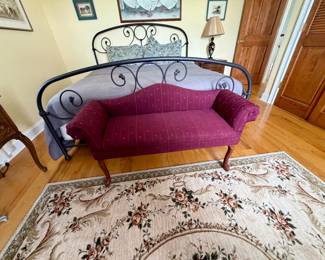 Burgundy settee with rolled arms