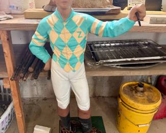 hand-painted lawn jockey statue wearing custom teal and yellow diamond racing silks