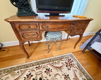 vintage French Provincial wooden vanity table featuring graceful cabriole legs and ornate brass hardware