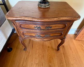 a vintage French Provincial style oak two-drawer nightstand 