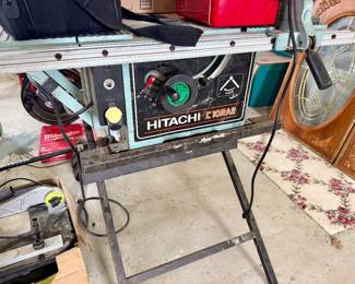 vintage Hitachi C10RA2 10-inch portable contractor's table saw mounted on a metal folding stand