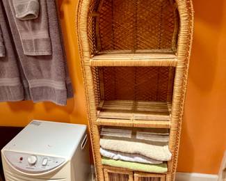 a vintage arched rattan and wicker shelving unit