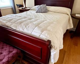 dark cherry wood sleigh bed frame with a classic curved headboard and footboard