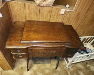 Antique white sewing machine with treadle and instructions