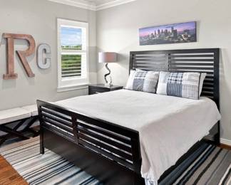 Queen, size bed, rug, nightstand, lamp, letters