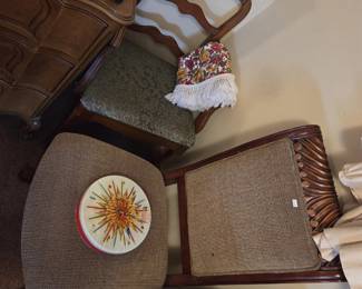 Seating group including a French Provincial ladder-back side chair with green damask upholstered seat, an upholstered ottoman in brown tweed, and a carved wood chair with rope-twist detailing and tweed cushion, plus a vintage floral fringed accent piece and a decorative tin.