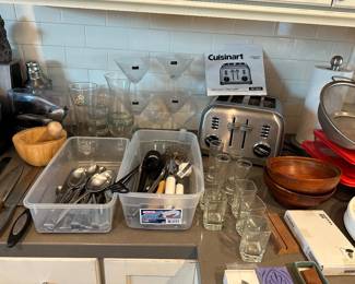 Cuisinart, four sliced toaster, fancy corkscrew, noon package, wood, mortar, and pesto, knives and kitchen utensils