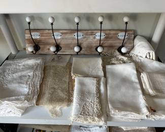 Decorative coat and hat rack, various linens include tablecloths, napkins