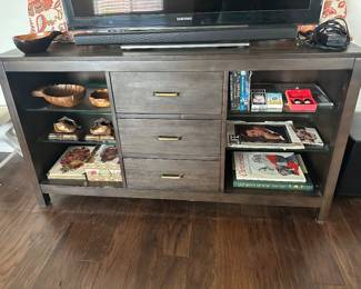 Media cabinet with three storage drawers and side glass shelves is 16 inches deep 219 inches deep at baseand 5 feet wide