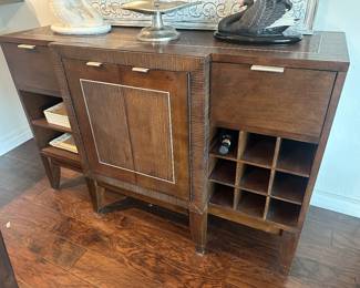 Stainless ribbed detail on stylish buffet with wine storage is 18 inches deep +2 in the center and 56 inches across