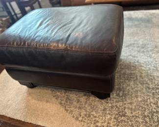 Brown leather ottoman is 21 x 30“