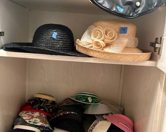On stool: Felt black hat w/ MINK Brim $75; visits $5ea; derby hat $25, black brimmed & yellow & pink rain hat $5ea; top shelf brimmed & black leather like w/ grommets $10ea