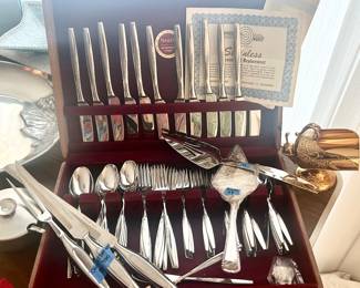 (12) 6pc place settings, 5 serving pcs Nakan - Japan Prudential Stainless “Spring Wheat” Flarware set in wood lined utensil box. 77pcs $150; carving fork + 2 knives $30