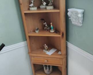 Corner shelves & gold & stone clowns by Ron Lee