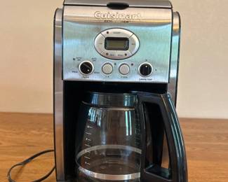 jq- This Cuisinart Extra Brew Coffee Maker features a sleek and durable stainless steel exterior, combining modern style with functionality. It includes a clear glass carafe with a black handle, a user-friendly control panel with an LCD screen, and simple buttons for easy brewing. The compact design is space-efficient, while a transparent water level indicator on the side ensures precise water measurement. Ideal for coffee lovers seeking a reliable and stylish coffee maker for daily use.