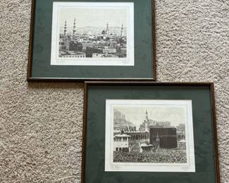 ds- Matched pair of framed black-and-white prints depicting the Islamic holy cities of Mecca and Medina in Saudi Arabia. One print is titled “La Mecque” and depicts the Kaaba and surrounding Masjid al-Haram filled with worshippers. The second is titled “La Médine” and presents a panoramic historic view of Medina with prominent mosque domes and minarets. Both are printed beneath the image “ESTAMPE DU XIXe SIÈCLE,” French for “19th-century print/engraving.” Arabic inscriptions also appear at lower right, identifying the respective holy cities and indicating an old or historical view. Based on the presentation and labeling, these appear to be later reproductions based on 19th-century images, rather than actual 19th-century engravings themselves. Both pieces are presented under glass with matching dark green mats and wood-tone frames.