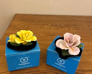 kv- These exquisite Napoleon porcelain flowers feature intricately crafted petals and realistic green leaves, showcasing fine attention to detail. Each flower measures approximately 3 inches in diameter and 2 inches in height, making them perfect for display in compact spaces. The set includes vibrant yellow and soft cream-colored flowers, mounted on a black velvet base that enhances their delicate beauty. Ideal as collectible decorative pieces or charming gifts, these porcelain flowers combine craftsmanship with elegant design.