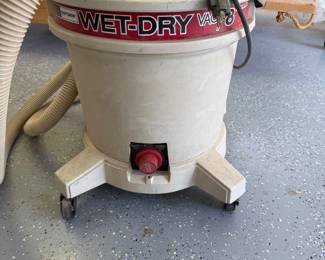 mk- This Craftsman 8 Gallon Wet/Dry Vacuum is designed for versatile cleaning tasks with the ability to handle both wet and dry debris. Featuring a sturdy beige body with red and black branding accents, it includes a durable hose and a robust wheeled base for easy mobility. Its 8-gallon capacity makes it suitable for medium to large cleanup projects, ideal for workshops, garages, and job sites.