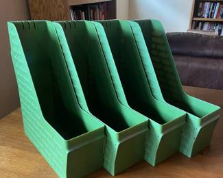 ly- This set of four Leitz letter file holders features a sturdy plastic construction with a textured design on the sides for enhanced grip and aesthetic appeal. The vibrant green color adds a retro touch ideal for organizing documents, magazines, or files in any office or home setting. Each holder is designed with a deep, angled slot to securely hold papers upright, and a front label holder for easy identification. The durable material ensures long-lasting use while maintaining a lightweight design for effortless handling and repositioning. L: 10in W: 4in H: 12.5in