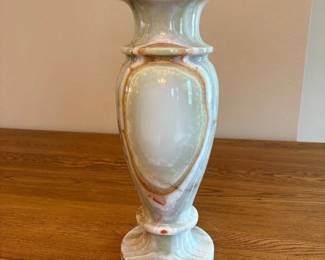 ba- This exquisite hand-carved vase is made from green and honey onyx marble, showcasing beautiful natural veining and color variations. Standing 15.5 inches tall and 6 inches wide, this vase features a classic shape with elegant curves and a flared rim, perfect for adding a touch of luxury to any decor. The smooth, polished surface highlights the rich tones and intricate patterns unique to onyx marble, making it a stunning centerpiece or gift.