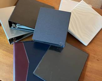 mc- This assortment features a variety of three-ring binders in multiple colors including black, white, navy blue with burgundy accents, and gray. The binders showcase different cover materials such as matte plastic, glossy plastic, textured fabric, and leather or leather-like finishes. Sizes appear to be primarily standard letter-sized designed for organizing documents or collections. Some binders have branding like 'FirstCommand' visible, while others are plain with a minimalist look. This diverse set is ideal for office, school, or home organization, combining practical functionality with distinct style options. 2 3inch Binders 3 2inch Binders 1 1inch Binder 1 L: 9.5in W: 8.5in H: 3in Binder