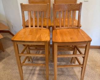 hj- This set of four bar stools features sturdy wooden construction with a natural finish, highlighting the warm honey-toned wood grain. Each stool includes a supportive backrest that measures 43.5 inches tall and a seat height of 30 inches, providing comfortable seating. The seat area measures approximately 19 by 17 inches, offering ample space. These bar stools are perfect for kitchen islands, bars, or high dining tables, combining functionality with a timeless design.