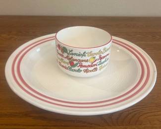 js- This charming ceramic soup bowl and serving dish set features vibrant Italian vegetable graphics around the bowl, including tomatoes, carrots, and other fresh produce. The bowl measures approximately 4 inches in height and 6 inches in diameter, while the accompanying serving dish is about 11 inches in diameter. Both pieces are accented with red stripes along the rims, creating a classic and colorful design perfect for serving soups or stews with style.