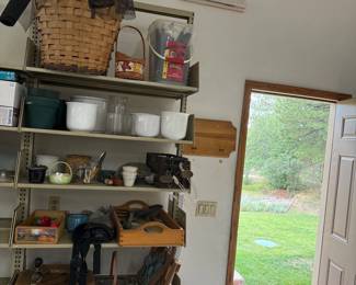 hr- This gardening supplies lot offers a diverse collection of essential items for gardening enthusiasts. Featuring multiple wooden trays, ceramic pots in white, glass jars, and various hand tools. The set includes large woven baskets, plastic green plant pots, garden scissors, and other small gardening accessories.