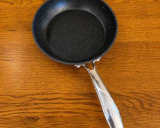 it- This Granite Stone Diamond Pro skillet set includes three skillets featuring a durable non-stick granite coating for excellent cooking performance and easy cleaning. The black speckled surface is both stylish and functional, providing even heat distribution. Each skillet has a comfortable, sturdy stainless steel handle for safe handling. One skillet measures approximately 8 inches in diameter, making the set versatile for various cooking needs.