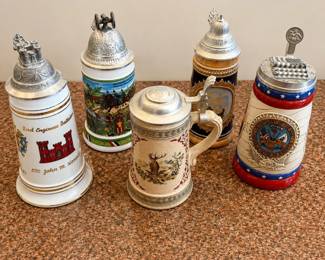 lk- This collection features a set of five authentic German-themed beer steins, each uniquely decorated with detailed artwork and traditional motifs. The steins are crafted from ceramic material with intricate painted designs showcasing rural and hunting scenes . Each stein is topped with a decorative pewter lid featuring various ornate shapes and thumb lifts for easy opening. The medium-sized steins combine aesthetic appeal with functional design, perfect for collectors or enthusiasts of German beer culture.