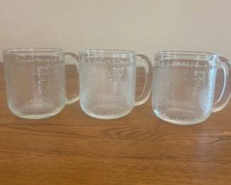 kf- This set includes three LITTALA KROOVI beer mugs, uniquely designed by the renowned Finnish designer Oiva Toikka. Each mug is crafted from clear textured glass, measuring approximately 3.25 inches in height and 3.5 inches in diameter, making them perfectly sized for enjoying your favorite beer. The mugs feature a distinctive bubbled texture that adds a unique tactile element and aesthetic appeal. These vintage glass mugs are both functional and collectible, showcasing Finnish design excellence.