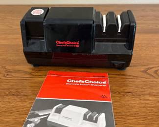 jf- This Chef'sChoice Diamond Hone Electric Knife Sharpener Model 110 is a compact and efficient kitchen tool designed to sharpen knives with precision. Featuring a black durable plastic body and a three-stage sharpening system, it ensures professional-grade sharpening at home. The sharpener measures approximately 7 inches in length and 3.5 inches in width, making it portable yet powerful. It includes an electrical cord for plug-in use, providing consistent power for optimal sharpening performance. Additionally, the device comes with a clear instruction manual for ease of use. Its sleek black design, sturdy construction, and effective diamond honing technology make it an essential accessory for any kitchen.