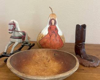 kq- This assorted collection of wooden collectibles showcases a beautifully hand-painted gourd with a distinctive design of a woman in a flowing red dress, standing at approximately 9 inches tall. The set also includes a rustic wooden bowl, a vintage-style wooden rocking horse, and a wooden cowboy boot sculpture, each crafted from natural wood and exhibiting a rich, warm brown finish. These items blend artistic detail with natural materials, perfect for collectors or those looking to add a touch of rustic charm to their home decor.