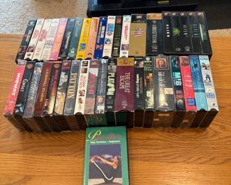 ct- This extensive VHS movie lot features a diverse collection of classic films along with a unique yoga instructional tape, Priscilla's Yoga Stretches for Beginners. The collection includes various genres, showcasing iconic titles in original VHS format, with colorful and detailed cover art. The tapes vary in condition and come in standard VHS cassette size and plastic cases. Ideal for collectors or enthusiasts of vintage media.