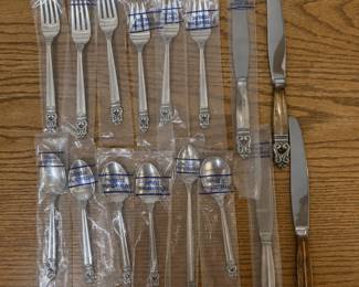 an- 16-piece grouping of International Silver Co. Royal Danish sterling silver flatware, a classic Scandinavian-inspired pattern introduced in 1939. Pieces feature the distinctive openwork scroll/acorn-style terminal and are marked “U.S.A. / ROYAL DANISH / INTERNATIONAL STERLING.” The Royal Danish pattern remains actively collected and replacement pieces command substantial retail prices. Includes: 3 dinner forks 3 salad forks 4 smaller spoons 1 soup spoon 1 dessert spoon 4 knives Many pieces remain sealed or stored in their original International Sterling plastic sleeves. One fork and two knives show some visible tarnish; otherwise condition appears very good from storage. Knives are typically constructed with sterling hollow handles and steel blades. 20.6 oz without knives.