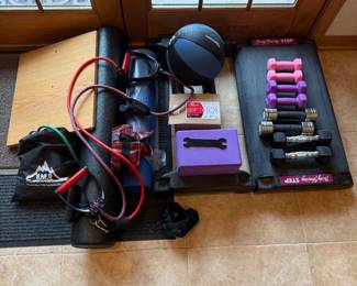 ik- This home gym equipment set features a variety of essential workout tools designed to support strength training, resistance exercises, and cardio routines. Included are multiple pairs of dumbbells in vibrant colors ranging from pink to black, a durable medicine ball, resistance bands with handles, and a cushioned yoga mat for floor exercises. The set also includes a purple yoga block, balance board, and an adjustable step platform marked 'Body Shaping STEP' for aerobic workouts. This set also includes a foam roller, perfect for recovery and stretching. Get an amazing workout with this set.