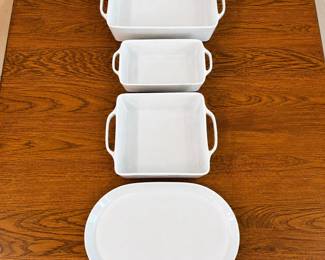 fa- This set features three high-quality Crate & Barrel baking dishes and a serving platter , crafted from durable white porcelain. Each dish is designed with convenient side handles for easy transport in and out of the oven. The dishes vary in size, with the largest measuring approximately 10 inches in length and 3.5 inches in height, making them perfect for a range of baking needs. The smooth, glossy porcelain finish not only provides a timeless look but also ensures easy cleaning and resistance to stains and odors. Ideal for baking, serving, and presenting your favorite dishes with style and practicality.