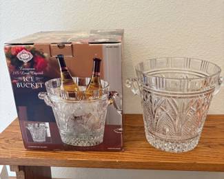 fi- Elegant Shannon European crystal ice bucket featuring 24% lead crystal for enhanced clarity and brilliance. This beautifully crafted piece measures 10 inches tall with a diameter of 9.75 inches. The intricate cut designs and sturdy handles add a touch of sophistication, making it perfect for entertaining or as a decorative centerpiece. Made from high-quality crystal, this ice bucket combines functionality with exquisite European craftsmanship.