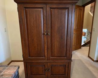 gt- This Lexington wood entertainment armoire offers sturdy construction and elegant design, perfect for housing your media equipment. Featuring a rich wood finish, it stands 65.5 inches tall, 36.5 inches wide, and 21.5 inches deep. The armoire includes multiple storage compartments, with a spacious upper cabinet designed to hold a television or other electronics, and lower cabinets for additional storage. Its classic style and solid wood build make it a functional and attractive addition to any living space.