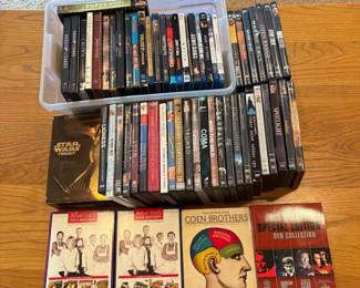 if- This extensive collection of DVDs and Blu-rays features a wide assortment of movies and TV series spanning various genres. Included are popular titles and box sets such as 'House of Cards,' 'The Crown,' 'True Grit,' 'Spotlight,' and more. The discs are neatly organized showcasing a variety of cases primarily in standard DVD and Blu-ray sizes. Perfect for movie enthusiasts looking to expand their home entertainment library with a diverse selection of films and series.