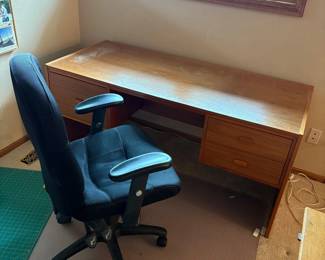 hn- This office furniture set features a large wooden desk and a comfortable ergonomic chair, perfect for any workspace. The desk measures 28 inches tall, 62 inches wide, and 27.5 inches deep, offering ample surface area and storage with multiple drawers for organization. The chair complements the desk with adjustable height, measuring 41 inches tall, 25 inches wide, and 20 inches deep, upholstered in a soft black fabric for added comfort. Both pieces showcase a sleek wood finish and sturdy construction, ideal for a productive office environment.