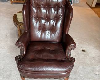 gp- Elegant dark brown tufted leather Chesterfield wingback armchair featuring classic craftsmanship and a comfortable design. This armchair measures 45 inches tall, 31 inches wide, and 28 inches deep, making it an ideal statement piece for any living space. The rich leather upholstery and detailed nailhead trim highlight its sophisticated style, while the tufted back and seat provide plush comfort. Perfect for adding a touch of traditional charm and luxury to your home.