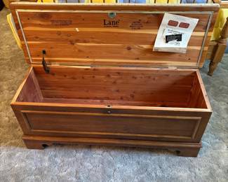 cx- This classic Lane cedar chest offers spacious storage with dimensions of 44 inches wide, 18 inches tall, and 15.5 inches deep. Crafted from natural cedar wood featuring Aroma-Tite construction, it ensures maximum protection against moisture and insects, preserving your stored items. The chest displays the authentic Lane branding from Altavista, Virginia, and includes original informational inserts about re-upholstering. Its warm cedar finish and sturdy build make it a beautiful and practical addition to any room for storing blankets, linens, or keepsakes.