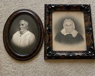 es- Pair of antique portrait photographs of elderly women in period frames. The oval portrait is housed in a faux-grain wood frame and features distinctive convex “bubble” glass. The second portrait is presented in an elaborate rectangular faux-grain frame with applied floral and scroll decoration and gilt-tone accents. Both portraits exhibit age-related toning and wear consistent with their age. Please review photos for condition. Square Frame: 27in x 23in Oval Frame: 25in x 18.5in