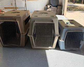 ml- This lot includes three pet kennels designed for safe and comfortable animal transport. The kennels feature sturdy plastic construction in neutral beige and gray tones, each equipped with metal mesh doors for ventilation and security. Sizes vary, with 2 of the largest kennel measuring 29 inches high, 33 inches wide, and 33 inches deep; the smallest kennel measuring 19 inches high, 24 inches wide, and 24 inches deep.