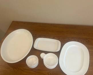 kb- This collection of white ceramic serving dishes includes multiple pieces designed for versatile use in your kitchen or dining area. Crafted from durable white ceramic, the set features bowls and plates of various shapes and sizes, including small handled bowls and larger oval and round dishes. The dishes have a clean, minimalist design with smooth finishes, perfect for both casual and formal dining settings. Measurements indicate compact sizes approximately ranging from 2 to 8 inches in diameter and about 2 to 3 inches in height, making them ideal for serving a variety of foods, dips, or side dishes.